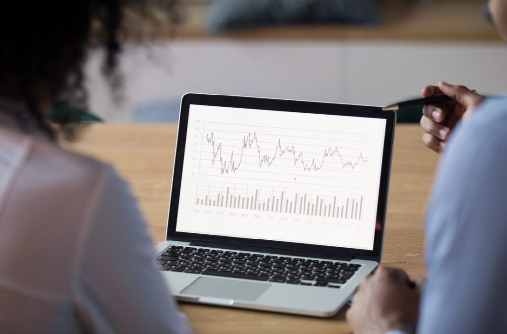 Colleagues analyzing business report on computer