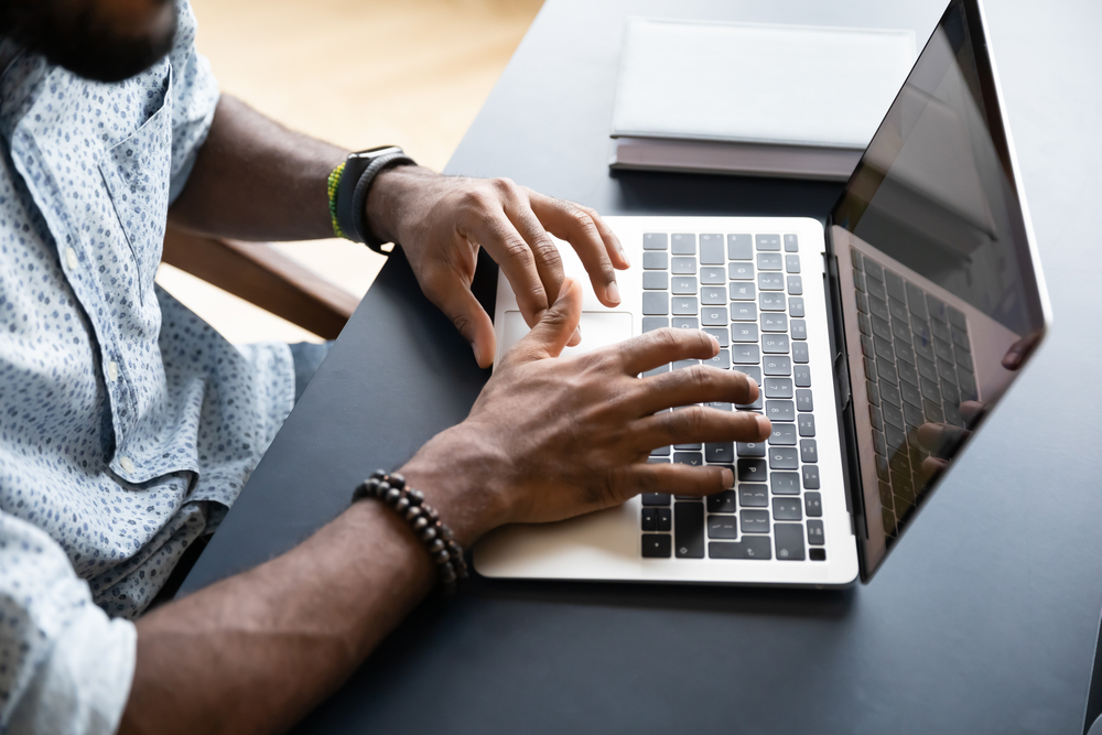 Close up of business man working on laptop