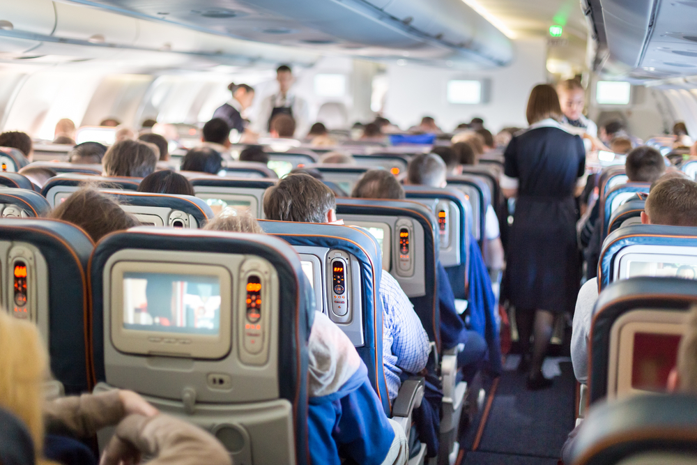 Interior of large passengers airplane with people