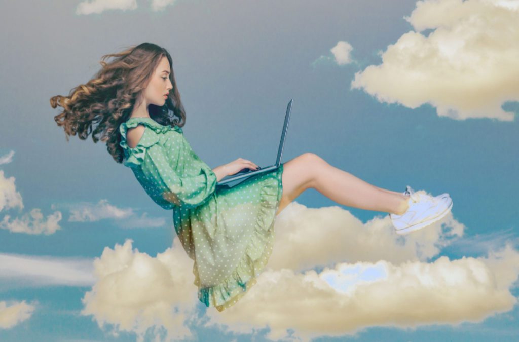 Woman with laptop sitting on a cloud of content